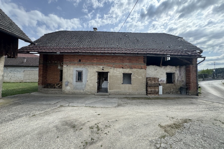 Verfallenes Bauernhaus mit Ziegelmauerwerk und beschädigtem Dach in Österreich